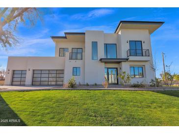 Modern two-story home with a three-car garage and landscaped lawn at 100 W Northern Ave # 15, Phoenix, AZ 85021