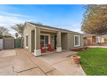 Charming single-story home with a cozy front porch and a well-manicured lawn at 1325 E Monte Vista E Rd, Phoenix, AZ 85006