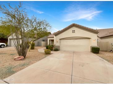 Attractive desert landscape front exterior with driveway and two-car garage at 15732 E Yucca Dr, Fountain Hills, AZ 85268