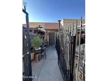 Home exterior with gated entry and walkway at 211 E Loma Linda Blvd # 2, Avondale, AZ 85323