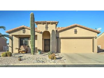 Charming single-story home featuring desert landscaping, a two-car garage, and a welcoming front entrance at 2101 S Meridian Rd # 131, Apache Junction, AZ 85120