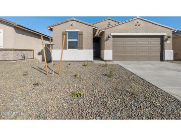 Inviting single-story home with a two car garage and desert landscaping at 16034 W Desert Hollow Dr, Surprise, AZ 85387