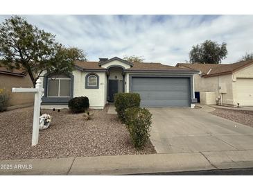 Charming single-story home with desert landscaping, a two-car garage, and neutral color scheme at 1812 E Peach Tree Dr, Chandler, AZ 85249