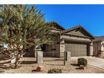 Single-story home with a two-car garage and desert landscaping at 30341 N Saddlebag Ln, San Tan Valley, AZ 85143