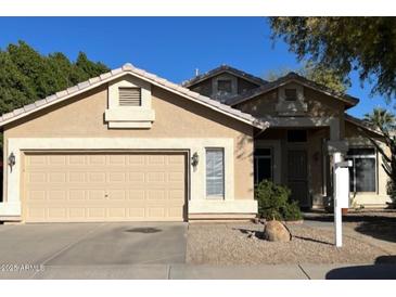 Tan one-story house with a two-car garage and landscaped yard at 4850 W Erie St, Chandler, AZ 85226