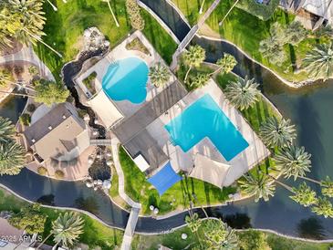 Aerial view of community pool and surrounding landscape at 2232 W Lindner Ave # 44, Mesa, AZ 85202