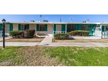 Front view of a charming single-story home with a well-manicured lawn at 10434 W Oakmont Dr, Sun City, AZ 85351