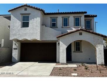 Two-story home with modern design, attached garage, and desert landscaping at 2200 N Iowa St, Chandler, AZ 85225