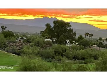 Stunning aerial view of property with mountain backdrop at sunset at 16804 E Monterey Dr, Fountain Hills, AZ 85268