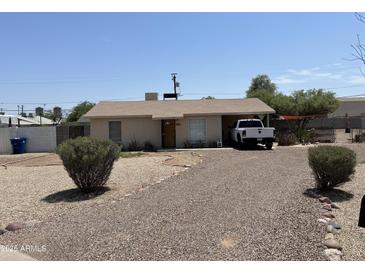 Charming single-story home features a gravel front yard and a convenient carport for covered parking at 925 E Henry St, Tempe, AZ 85288