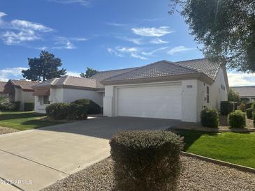 Single-story home with attached garage and well-manicured lawn at 14129 W Sky Hawk Dr, Sun City West, AZ 85375