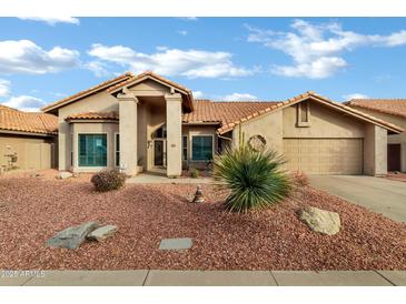 Single-story house with desert landscaping and two-car garage at 9478 E Corrine Dr, Scottsdale, AZ 85260