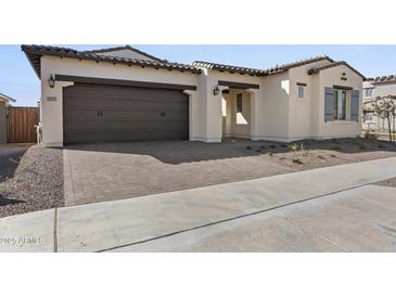 One-story home with brown garage door and landscaping at 2233 W Hide Trl, Phoenix, AZ 85085