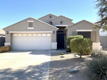 One-story house with a two-car garage and desert landscaping at 34365 N Barzona Trl, San Tan Valley, AZ 85143