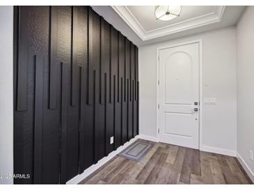 Modern entryway with black accent wall and wood-look floors at 4360 N 186Th Ln, Goodyear, AZ 85395