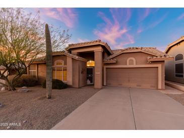 Single-story house with a two-car garage and desert landscaping at 8546 E Brittle Bush Rd, Gold Canyon, AZ 85118