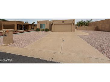 Charming single-story home featuring a desert landscape, concrete driveway, and attached two-car garage at 9346 E Citrus N Ln, Sun Lakes, AZ 85248