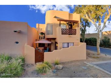 Charming exterior with a balcony, private entrance, and stucco architecture in a desert landscape at 6411 S River Dr # 26, Tempe, AZ 85283