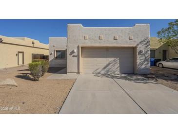 Charming home featuring a two-car garage and well-maintained desert landscaping at 3948 W Salter Dr, Glendale, AZ 85308