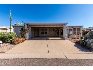 Charming single-story home with covered parking and well-maintained desert landscaping at 215 N Power Rd # 361, Mesa, AZ 85205