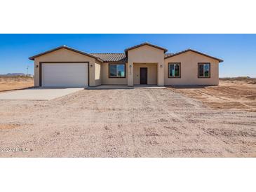 Newly constructed single-story home with a two-car garage and neutral color palette at 6300 N 419Th Ave, Tonopah, AZ 85354