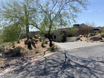Inviting exterior view of a home featuring desert landscaping and a stone-paved driveway leading to the entrance at 10336 E Chia Way, Scottsdale, AZ 85262
