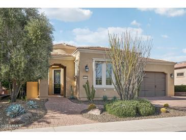 Beautiful desert landscape surrounds this single-story home with a welcoming front porch at 28728 N 129Th Ln, Peoria, AZ 85383