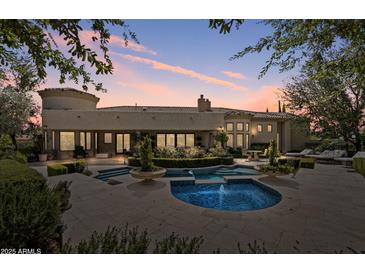 Stunning backyard pool and spa with lush landscaping, perfect for outdoor entertaining and relaxation at 6322 E Turquoise Ave, Paradise Valley, AZ 85253