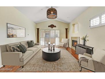 Bright living room featuring elegant decor, fireplace, and sliding glass door at 8653 E Royal Palm Rd # 2005, Scottsdale, AZ 85258