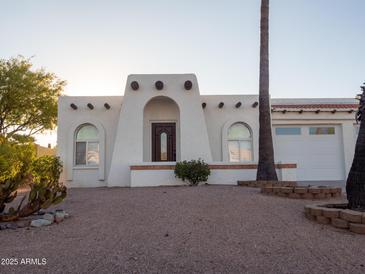 Charming home with arched windows, stucco facade, and desert landscaping for a unique southwestern curb appeal at 14211 N Fountain Hills Blvd # B, Fountain Hills, AZ 85268