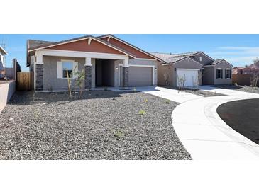Charming single-story home showcasing a desert landscape, covered porch, and a two-car garage at 28233 N 134Th Ave Ave, Peoria, AZ 85383