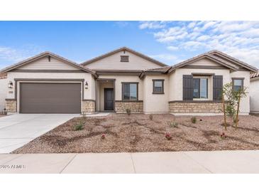 Single-story home with a brown garage door and landscaping at 37767 W Padilla St, Maricopa, AZ 85138