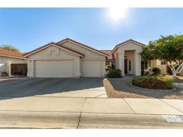 Single-story home with two-car garage and landscaped front yard at 5827 W Charter Oak Rd, Glendale, AZ 85304