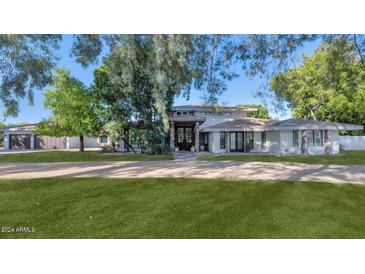 Stunning single-story home with a large front yard and attached garage at 6319 E Mariposa St, Scottsdale, AZ 85251