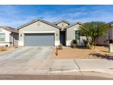 Single-story home with gray siding and a two-car garage at 7834 W Forest Grove Ave, Phoenix, AZ 85043