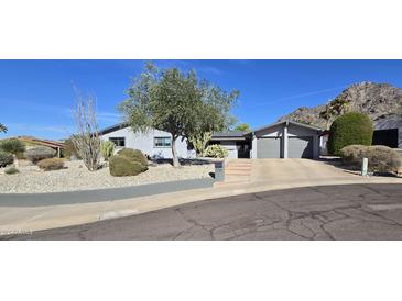 Single-story home with gray exterior, two-car garage, and landscaped yard at 2237 E Nicolet Ave, Phoenix, AZ 85020