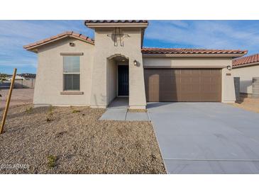 New construction home with attractive curb appeal and two-car garage at 24144 W Gibson Ln, Buckeye, AZ 85326