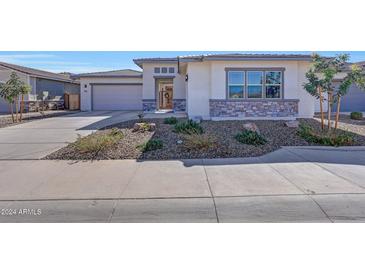 Single-story home with a two-car garage and desert landscaping at 13487 W Roy Rogers Rd, Peoria, AZ 85383