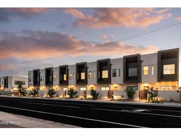 Modern townhome community with attached garages, sleek design, and landscaped grounds at 4050 N 12Th St # 3, Phoenix, AZ 85014
