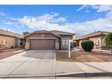 Single-story home with a two-car garage and landscaped front yard at 15829 W Carmen Dr, Surprise, AZ 85374