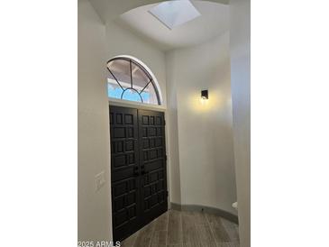 Elegant entryway with double doors and skylight at 7955 E Chaparral Rd # 103, Scottsdale, AZ 85250