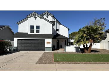 Stunning two-story home with a modern design and landscaped front yard at 8050 E Tuckey Ln, Scottsdale, AZ 85250