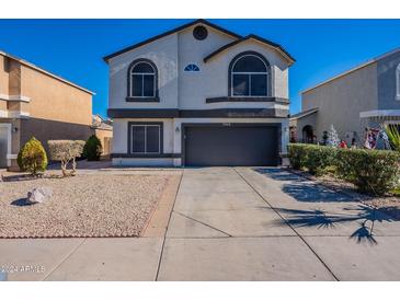 Two-story house with a two-car garage and landscaped front yard at 7313 N 69Th Ave, Glendale, AZ 85303