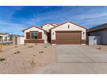 Single-story house with brown garage door and landscaping at 7280 E White Tail Rd, San Tan Valley, AZ 85143