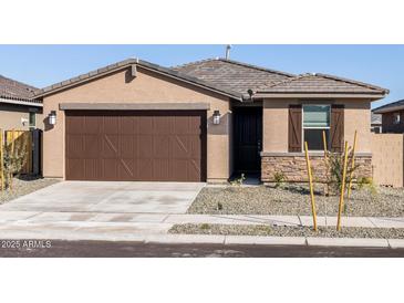 Charming single-story home with a two-car garage, stone accents and low maintenance desert landscaping at 16032 W Desert Hollow Dr, Surprise, AZ 85387