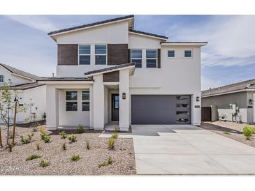 Contemporary two-story home featuring a gray garage door and neutral-colored stucco facade at 3247 W Garnet St, San Tan Valley, AZ 85144