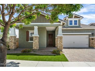 Craftsman style home with stone accents and a two-car garage at 10605 E Monterey Ave, Mesa, AZ 85209