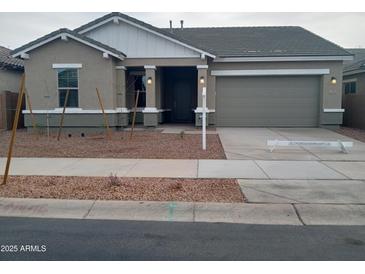 Charming single-story home with a well-maintained lawn and a two-car garage in a quiet neighborhood at 21039 E Poco Calle St, Queen Creek, AZ 85142