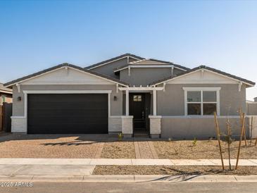 Gray one-story house with a two-car garage and landscaped front yard at 4045 S 177Th Ln, Goodyear, AZ 85338