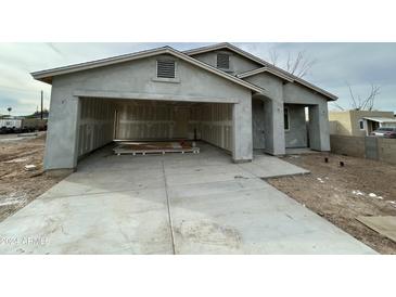 Newly constructed home with attached garage and open driveway at 11474 N 79Th Dr, Peoria, AZ 85345